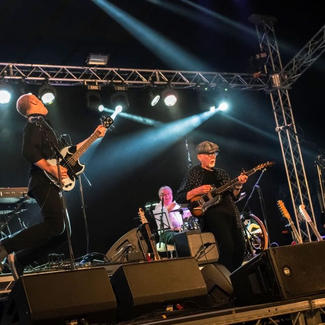 Men on stage from the band LINDISFARNE performing